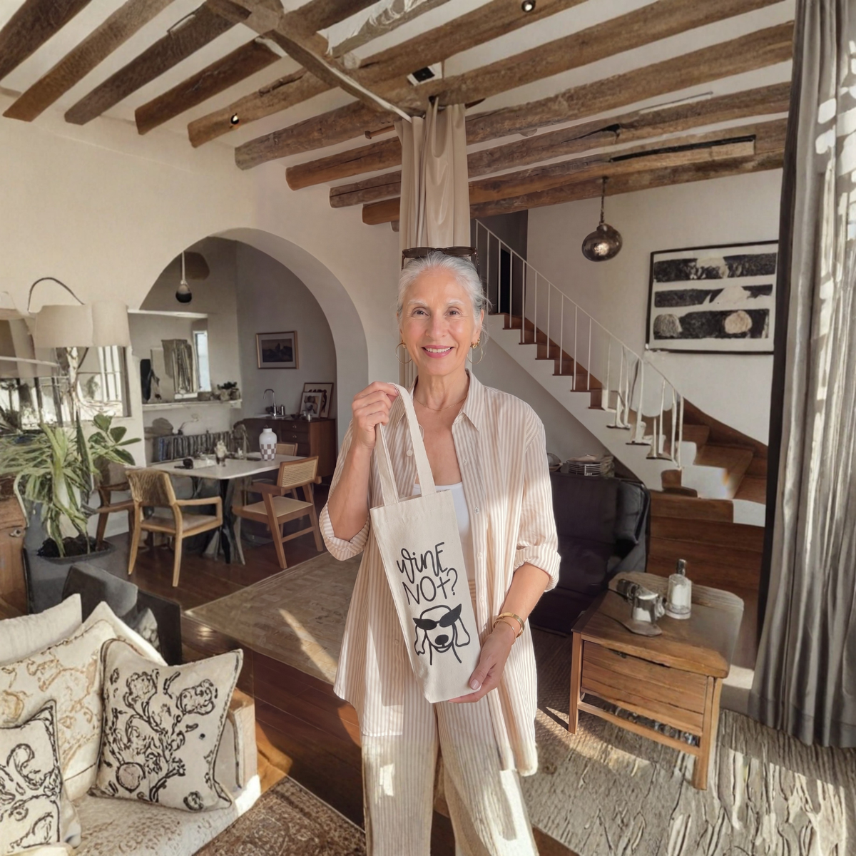 Woman holding a tote bag in a stylish living room with wooden beams and modern decor.